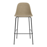 Beige upholstered barstool with a subtle texture and sleek black metal legs, perfect for modern decor.