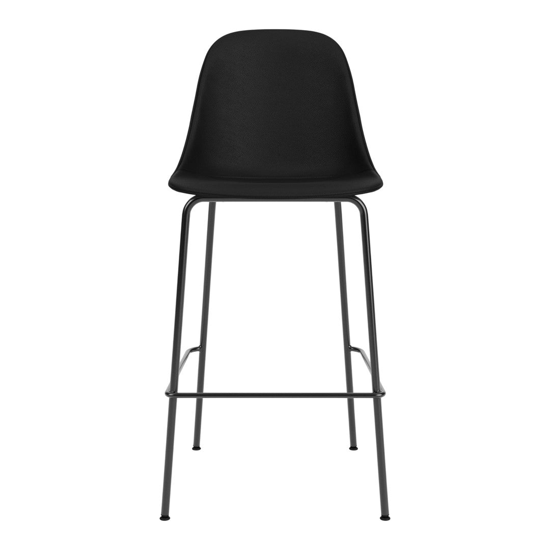 Modern black bar stool with a sleek silhouette and minimalist design, featuring a smooth plastic seat and sturdy metal legs.