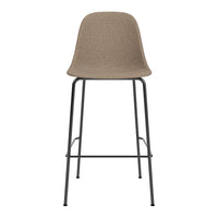 Tan woven chair with smooth curves and a black metal frame, featuring a minimalist design. Perfect for modern decor.