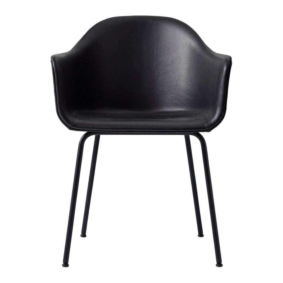 Black leather chair with sleek curves and minimalist black metal legs, perfect for modern decor.
