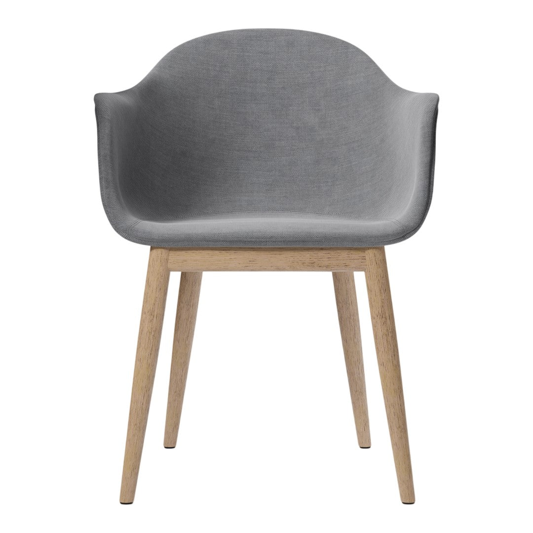 Gray upholstered chair with soft curves and light wood legs, perfect for modern decor. Simple and elegant design.