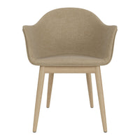 Beige upholstered chair with smooth curves and light wooden legs, featuring a minimalist design for modern interiors.