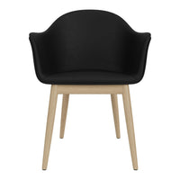 Modern black chair with curved back and natural wooden legs, stylish and comfortable design. Perfect for any decor.