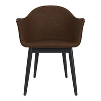 Brown fabric chair with a curved backrest and black wooden legs, showcasing a modern, minimalist design.