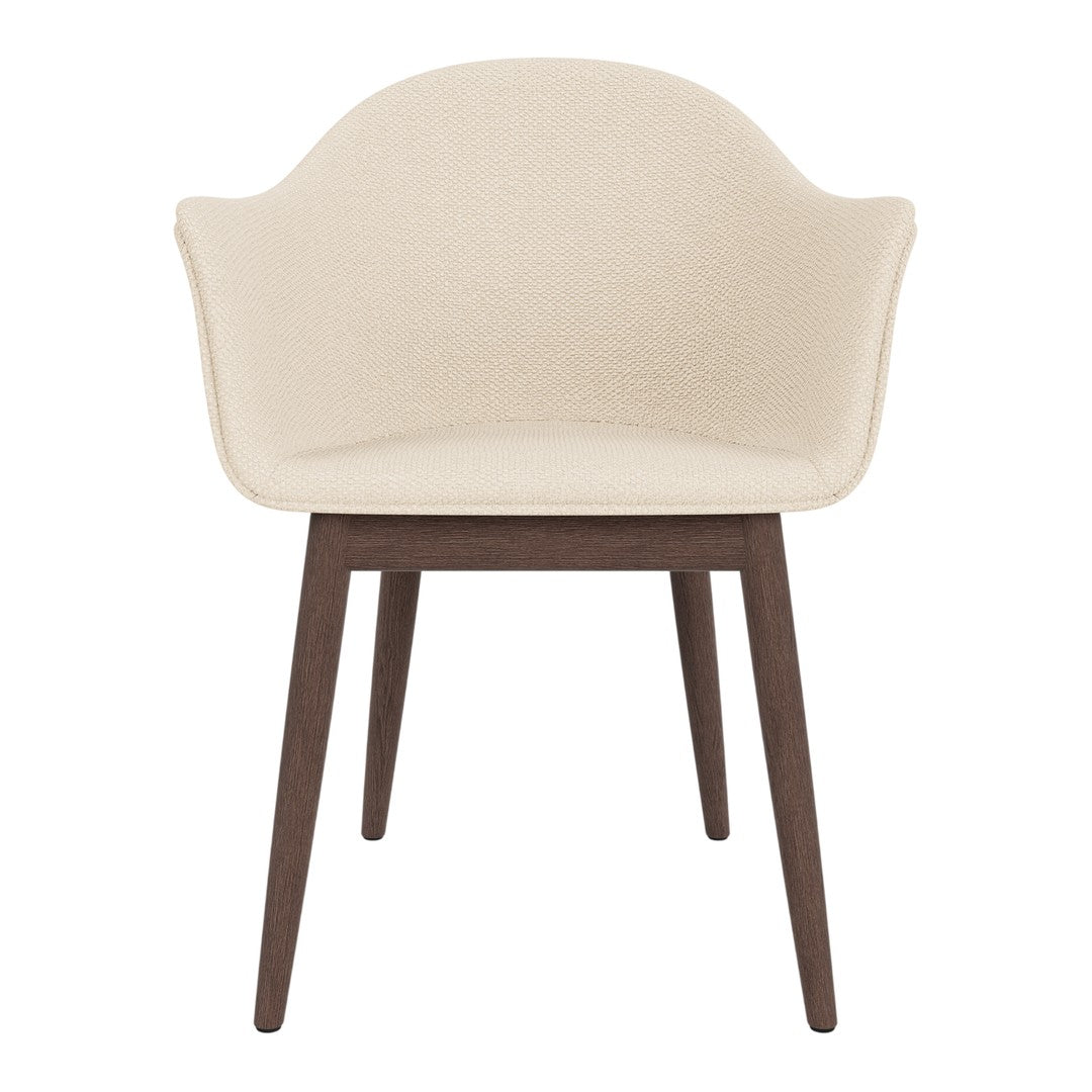 Cream upholstered chair with a smooth finish and dark wooden legs. Elegant and modern design for any space.