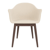 Cream upholstered chair with a smooth finish and dark wooden legs. Elegant and modern design for any space.