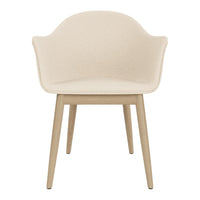 Beige upholstered chair with a smooth surface and natural wood legs, featuring a modern, minimalistic design.