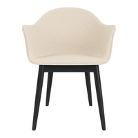 Beige upholstered chair with black wooden legs, featuring a sleek, minimalist design. Perfect for modern decor.