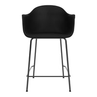 Black bar stool with a smooth, rounded seat and minimalist metal legs, perfect for modern decor.