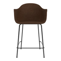 Brown upholstered bar stool with a textured fabric and sleek black metal legs. Modern and chic design.