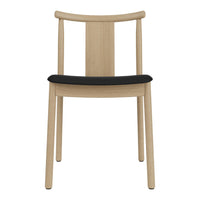 Light wood chair with a sleek black cushion, featuring a minimalistic design and smooth finishes.