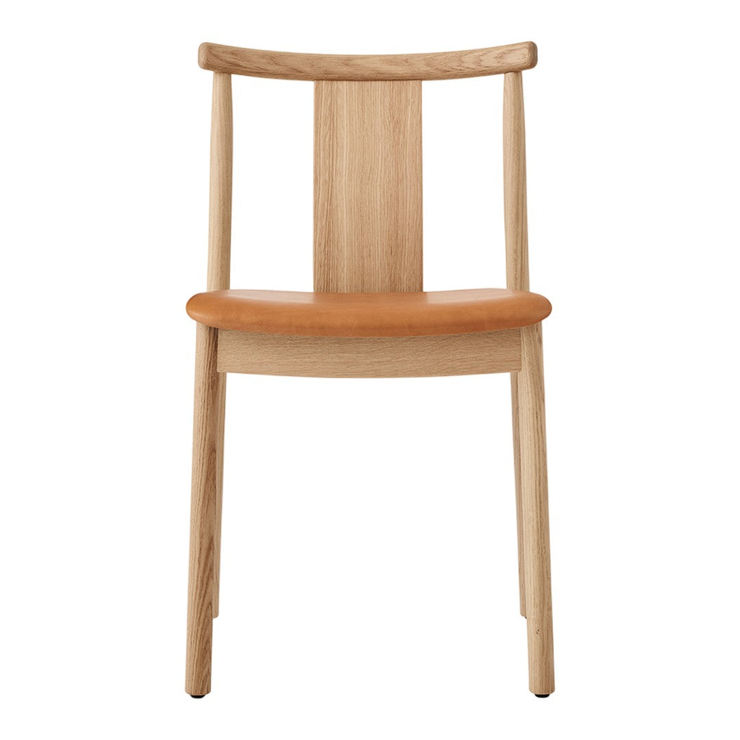 Natural wood chair with a light oak finish and a warm, tan leather seat. Simple, elegant design.