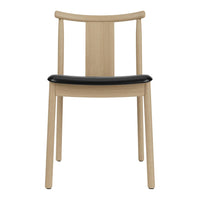 Beige wooden chair with a sleek black seat, featuring a minimalistic and modern design.