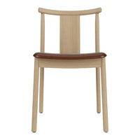 Light wood chair with a smooth, natural finish and a contrasting brown leather seat. Minimalist design, stylish and functional.