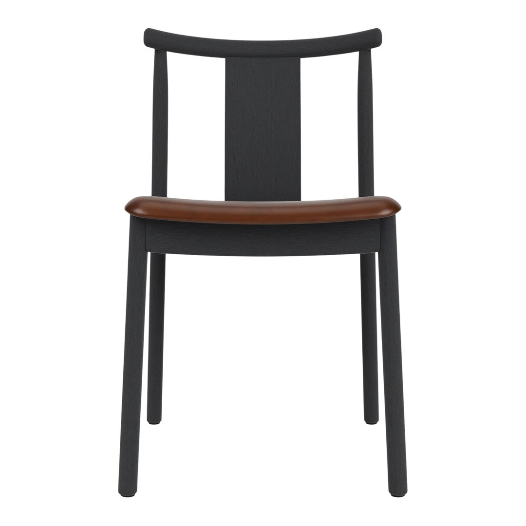 Black wooden chair with a sleek design and a contrasting brown leather seat. Minimalist aesthetic and modern appeal.