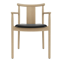 Light oak wooden chair with black seat cushion and minimalist design, featuring straight lines and smooth curves.