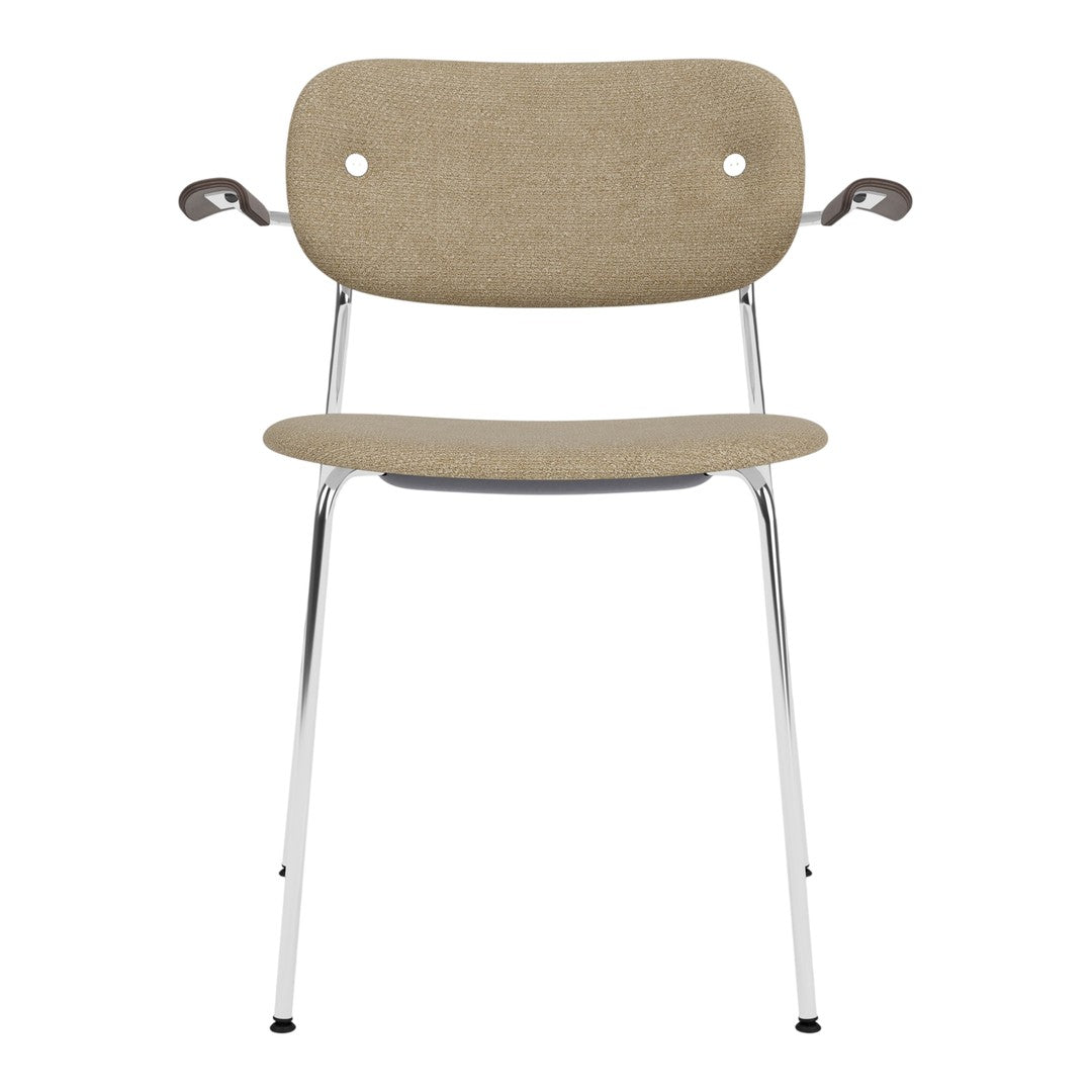 Beige upholstered chair with two circular cutouts, chrome legs, and minimalist design. Perfect for modern decor.