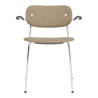 Beige upholstered chair with two circular cutouts, chrome legs, and minimalist design. Perfect for modern decor.