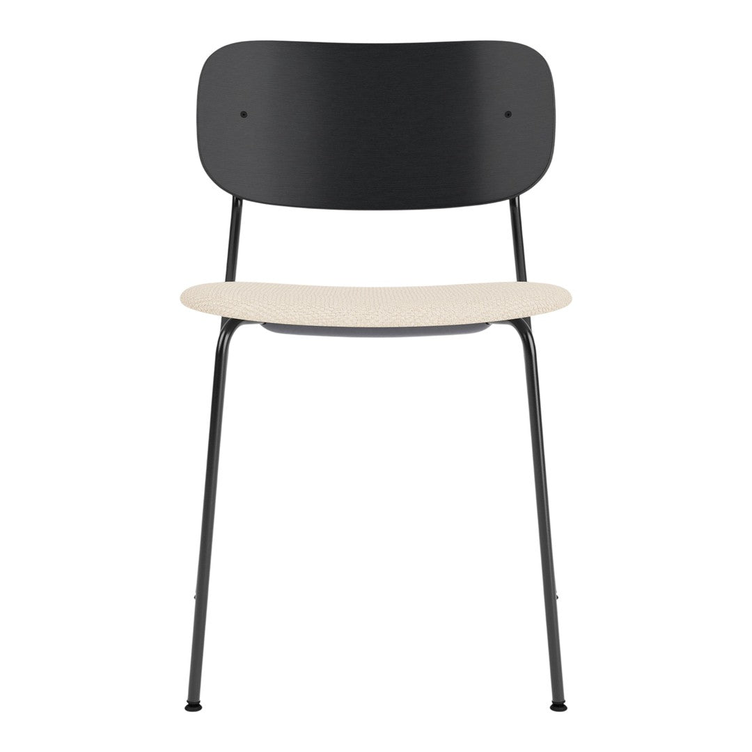 "Black metal chair with a smooth beige seat, minimalist design, perfect for modern interiors."
