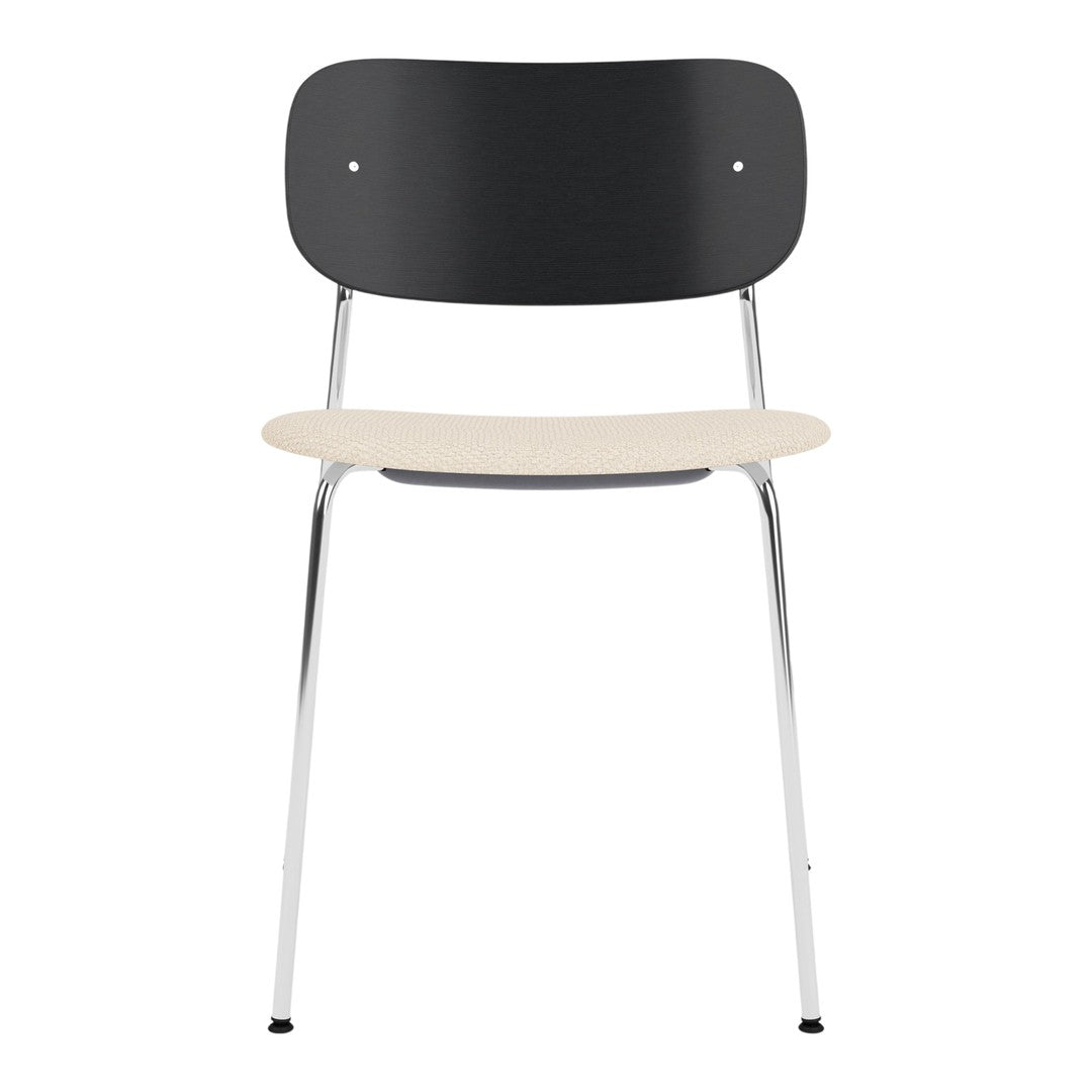 Modern chair featuring a black backrest, cream seat, and sleek chrome legs for a minimalist aesthetic.