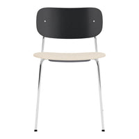Modern chair featuring a black backrest, cream seat, and sleek chrome legs for a minimalist aesthetic.