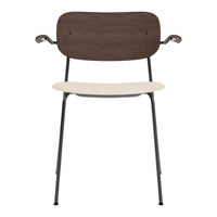 Wooden chair with a dark brown back, cream seat, and black metal legs; modern, minimalist design.