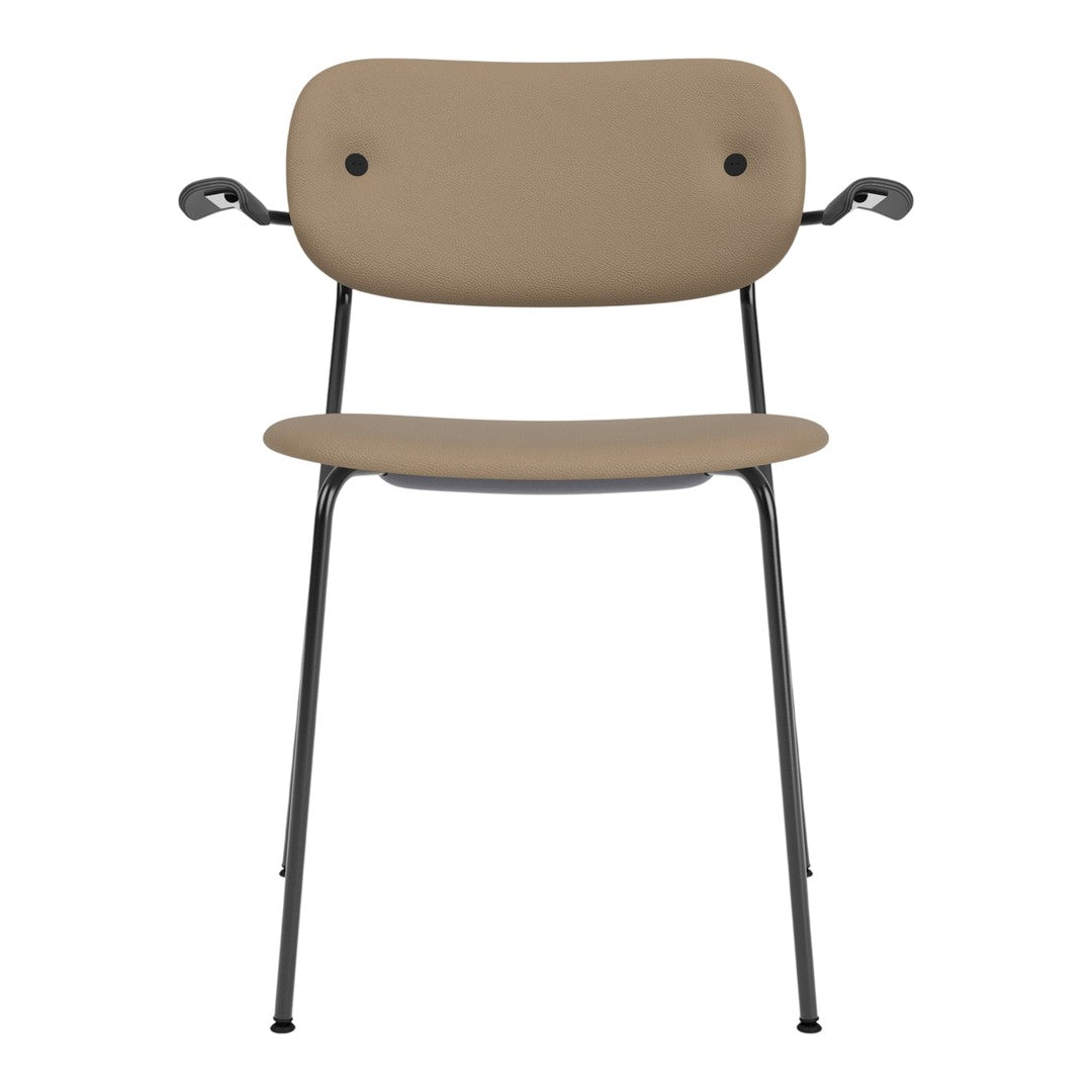 Tan chair with a minimalist design, featuring a smooth surface and black metal legs. Perfect for modern decor.