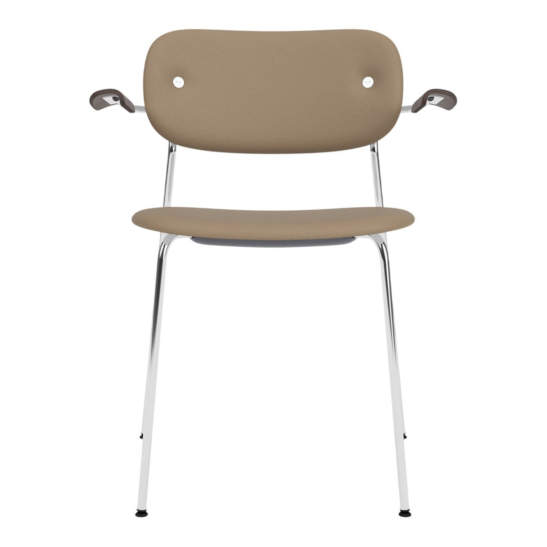 Beige chair with a smooth, minimalist design and chrome legs, featuring subtle round back holes for a modern touch.