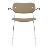Beige chair with a smooth, minimalist design and chrome legs, featuring subtle round back holes for a modern touch.