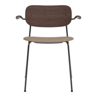 Brown wooden backrest and beige seat on a sleek black metal frame chair. Modern and minimalistic design.