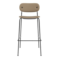 Tan upholstered bar stool with minimalist design and sleek black metal legs. Perfect for modern interiors.
