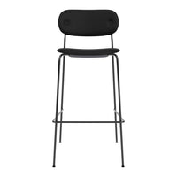 Black bar stool with a sleek, minimalist design and rounded backrest, featuring a matte finish and sturdy metal legs.