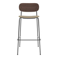 Modern bar stool featuring a dark wood backrest and a light wood seat, set on a sleek black metal frame.