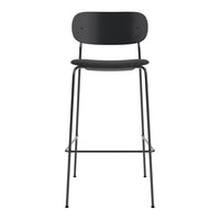 Black metal bar stool with a minimalist design, featuring a smooth matte finish and simple round patterns.