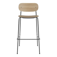 Natural wood grain seat with a sleek black metal frame, modern design minimalism in neutral tones.