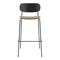 Black and natural wood bar stool with a minimalist design and sleek lines. Perfect for modern decor.