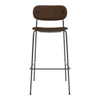 Brown fabric bar stool with a minimalist metal frame, featuring simple, clean lines and a sleek silhouette.