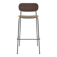 Modern bar stool featuring a dark wood backrest and a light wood seat, paired with a sleek black metal frame.