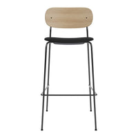 Tall bar stool featuring a natural wood backrest and black seat, set on a sleek black metal frame.