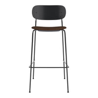 Black metal bar stool with a wooden seat, featuring a sleek, minimalist design. Ideal for modern spaces.