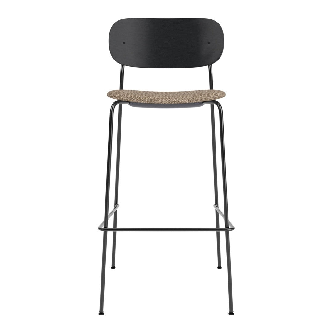Black metal bar stool with a natural cork seat, featuring a sleek and minimalist design.
