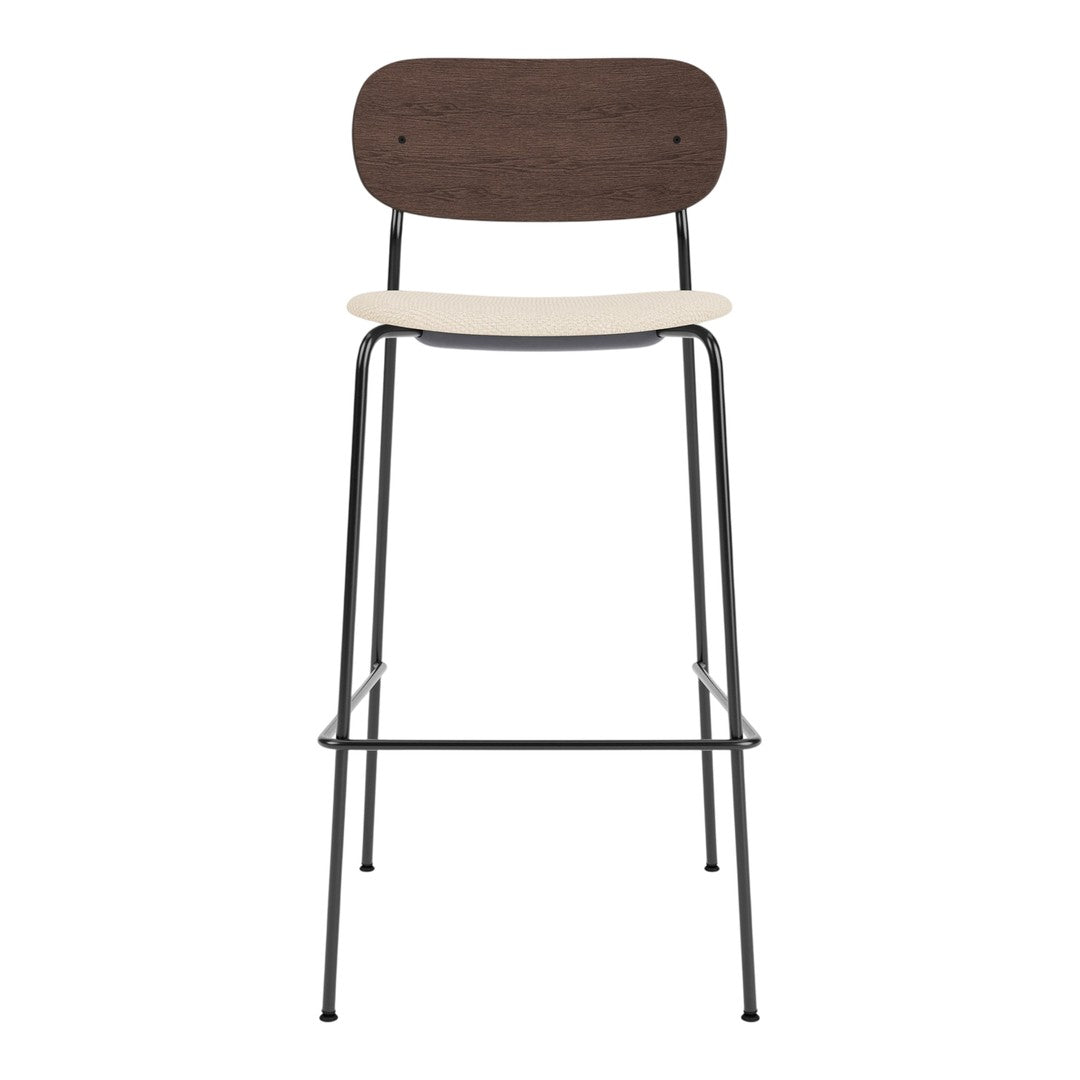 Brown wooden backrest and cream seat on a sleek black metal frame barstool. Minimalist design.