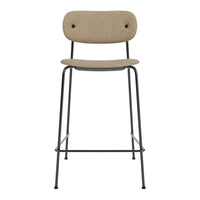 Beige upholstered bar stool with black metal legs and simple, modern design.