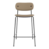 Tan upholstered stool with a sleek black metal frame, featuring a minimalist design and round backrest.