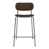 Brown upholstered bar stool with a minimalist design and black metal legs. Perfect for modern interiors.
