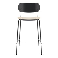 Modern black and beige bar stool with a minimalist design, featuring a sleek metal frame and smooth wooden seat.