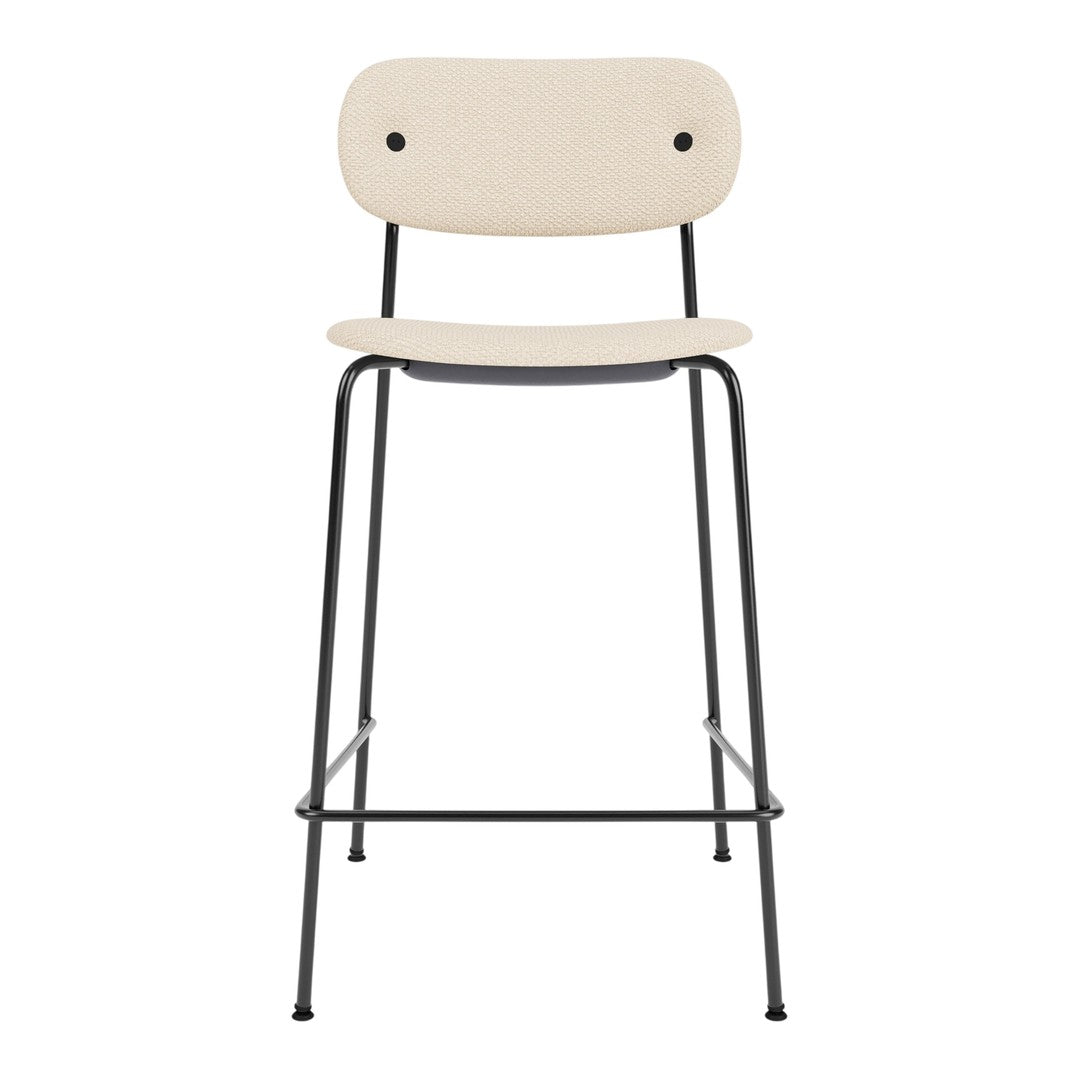 Beige upholstered bar stool with a minimalist design and black iron legs. Simple, modern aesthetic for stylish decor.
