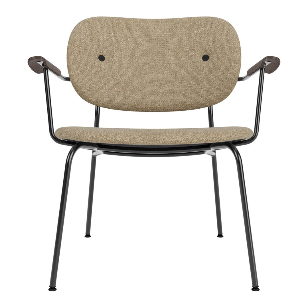 Beige upholstered chair with black metal frame and curved armrests, featuring minimalist design and subtle textures.