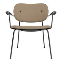 "Stylish beige chair with a smooth finish and black metal legs, featuring a minimalist design and two button accents."