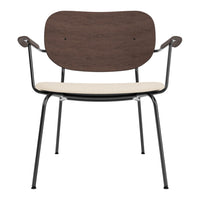 Brown wooden backrest, cream seat, and black metal frame dining chair. Stylish minimalist design for modern decor.
